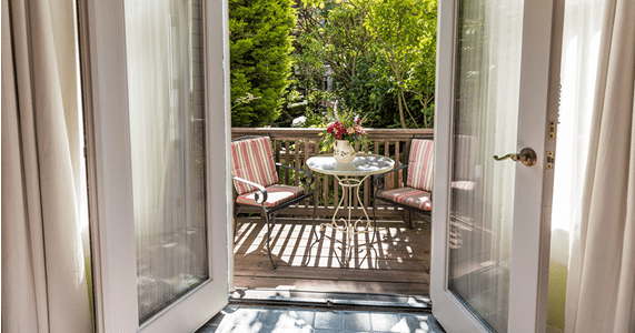 Opened balcony door with seating area